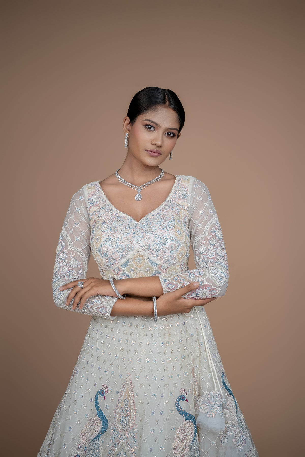 Ivory Peacock design lehenga best suited for engagement or reception wear