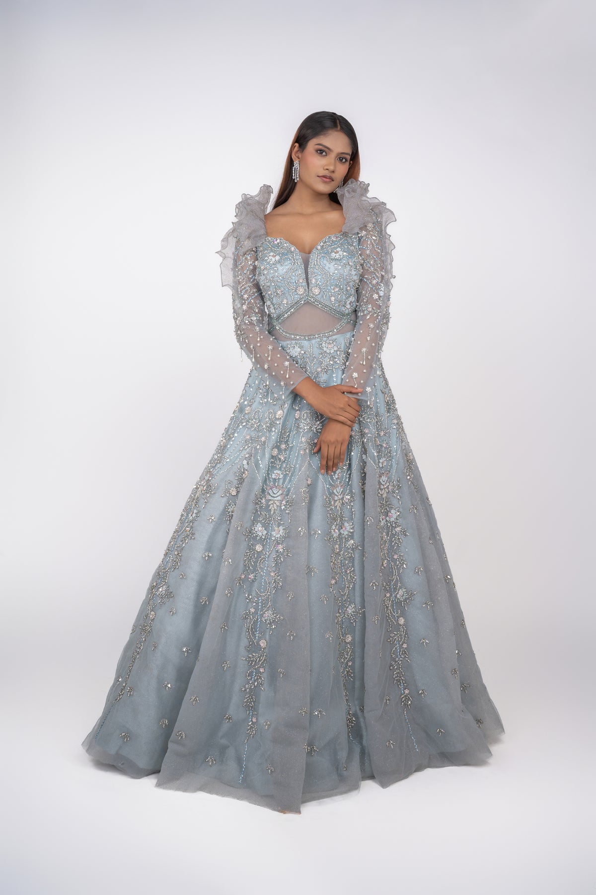 designer net gown with heavy work and sequin work and ruffle pattern on shoulders.
