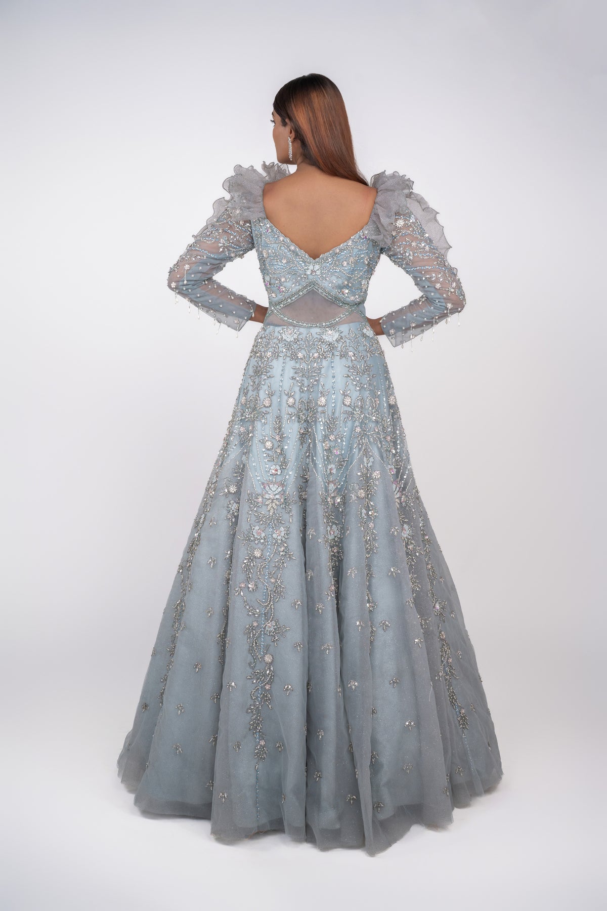 designer net gown with heavy work and sequin work and ruffle pattern on shoulders.