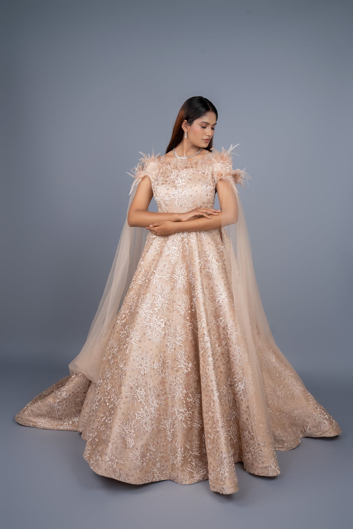 Beige Gold colour gown with long tail cut