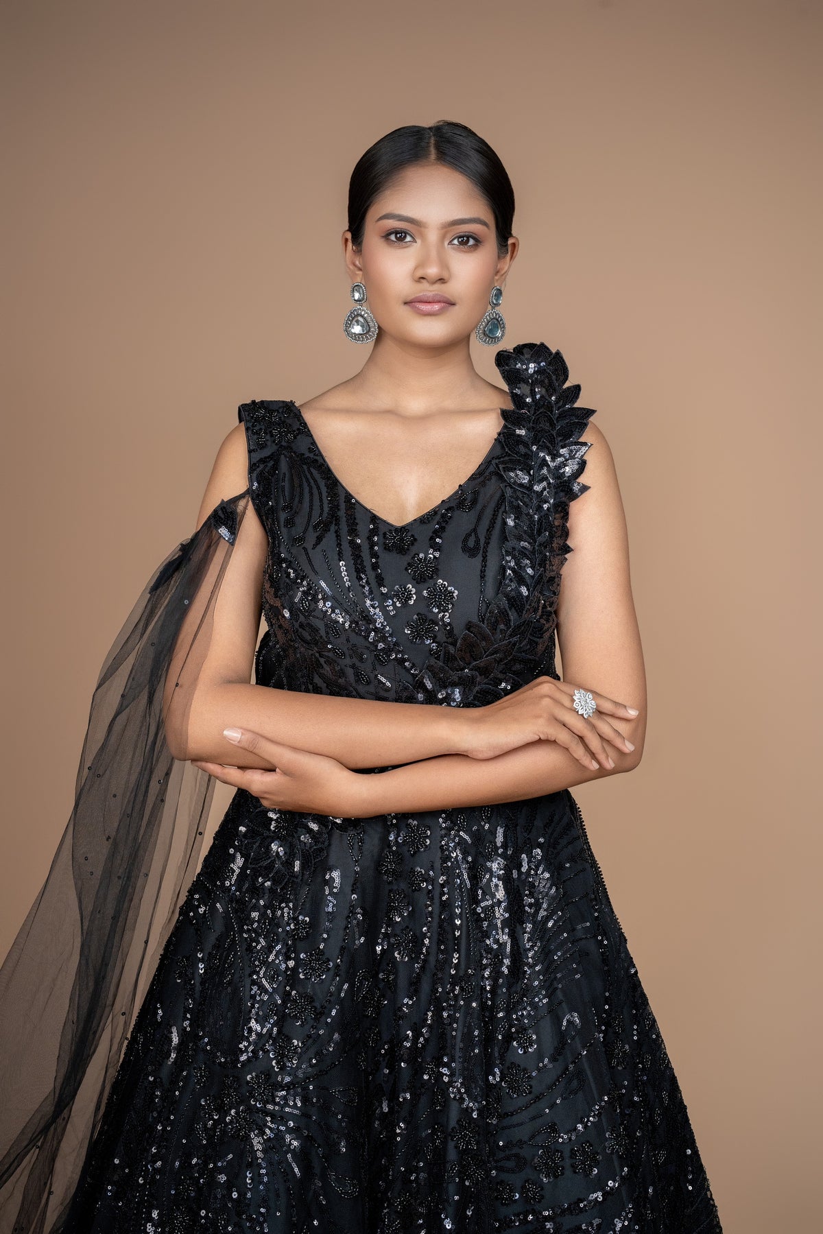 western gown in black colour with selfie sleeves on one side. and ruffle pattern on another.