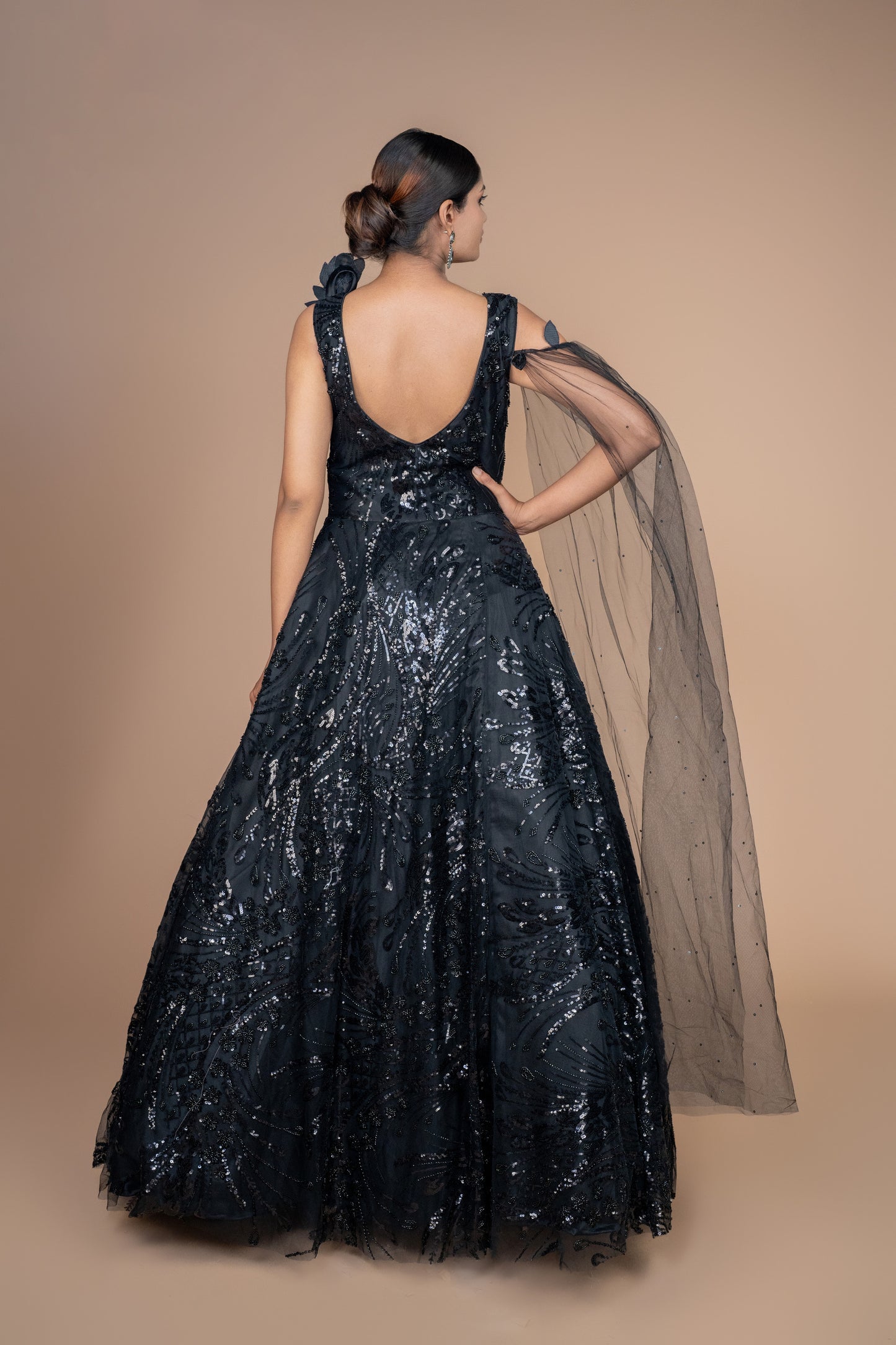 western gown in black colour with selfie sleeves on one side. and ruffle pattern on another.