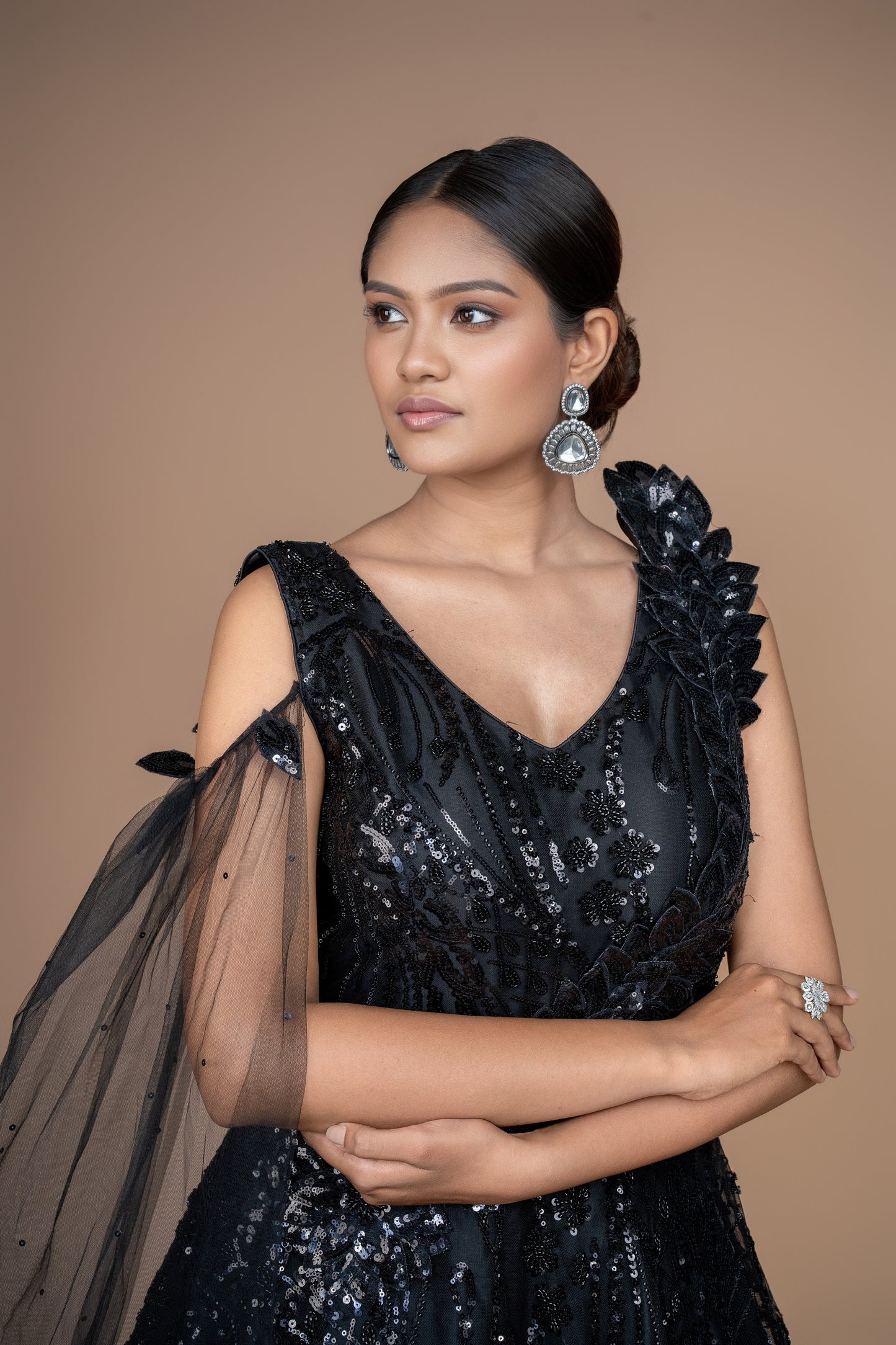 western gown in black colour with selfie sleeves on one side. and ruffle pattern on another.