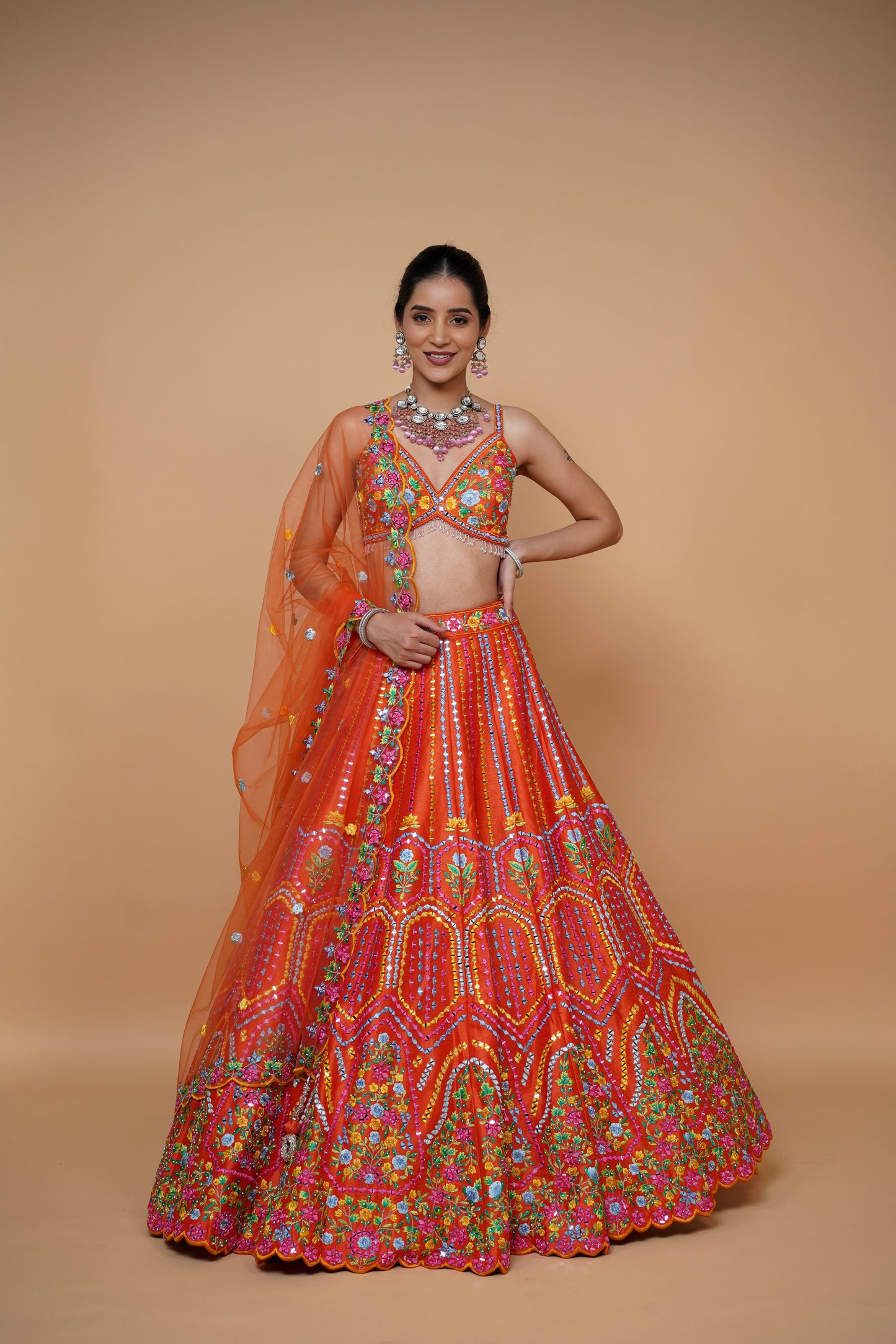 rust colour lehenga with mirror work and designer blouse design and net dupatta