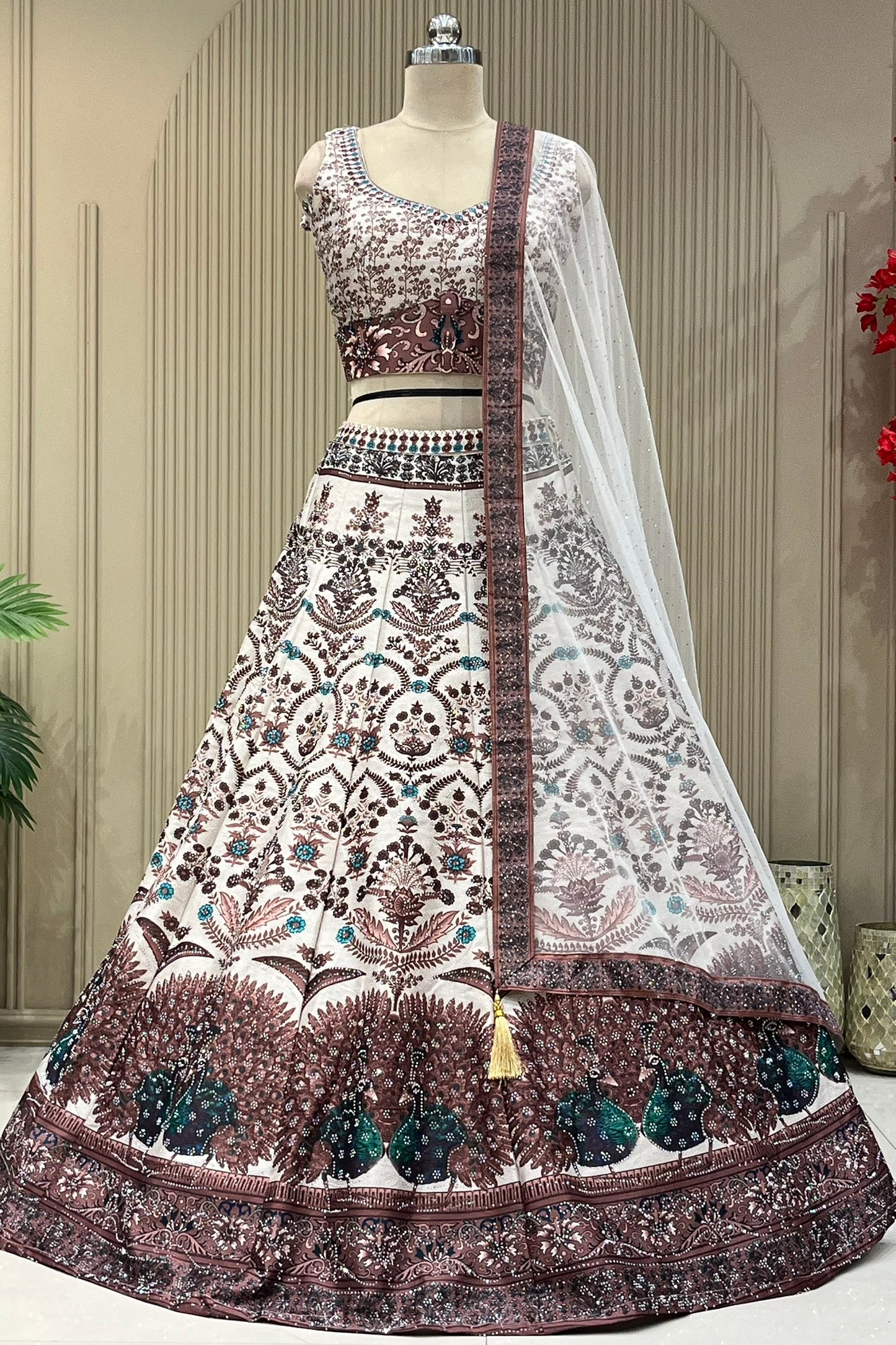 Ivory lehenga set showing peacock border hem and net dupatta drape