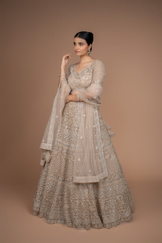 Front view of a luxurious timeless golden designer lehenga for weddings by Urban Dulhaniya.