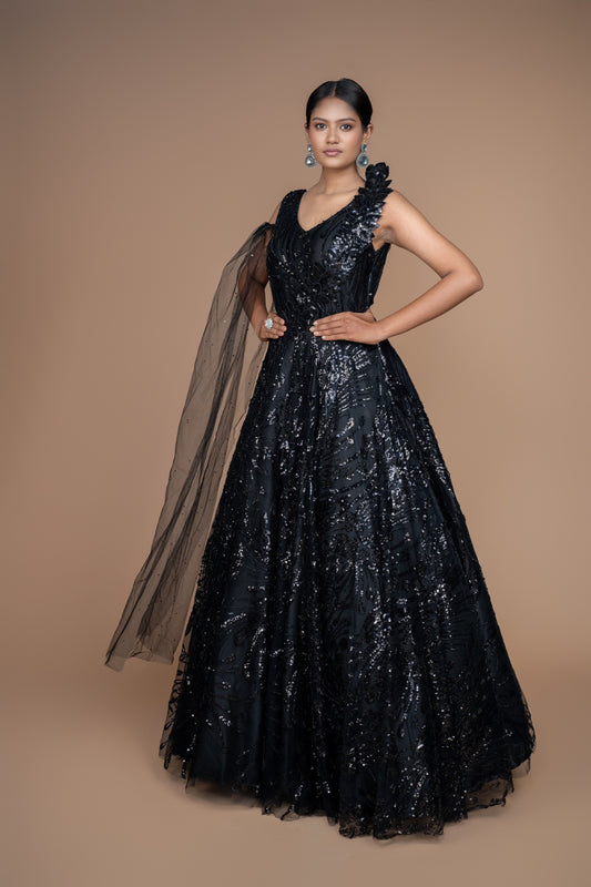 western gown in black colour with selfie sleeves on one side. and ruffle pattern on another.
