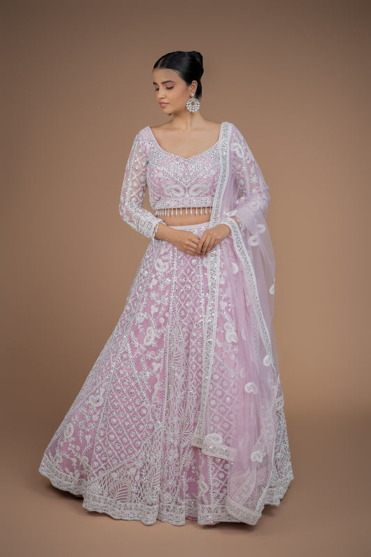 Front view of a dreamy powder pink and off-white dori work full sleeve lehenga by Urban Dulhaniya