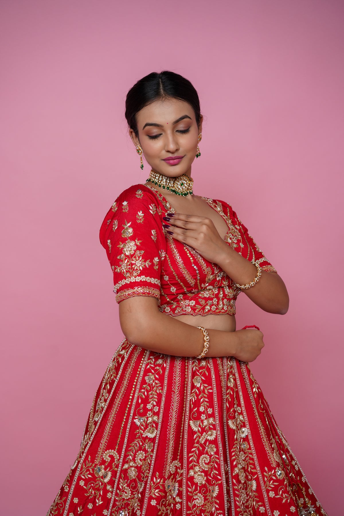 Close up of handmade zarkan embroidery on red bridal lehenga