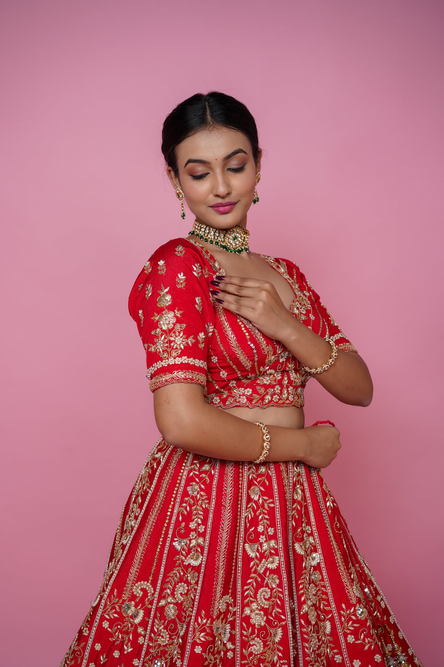 Close up of handmade zarkan embroidery on red bridal lehenga