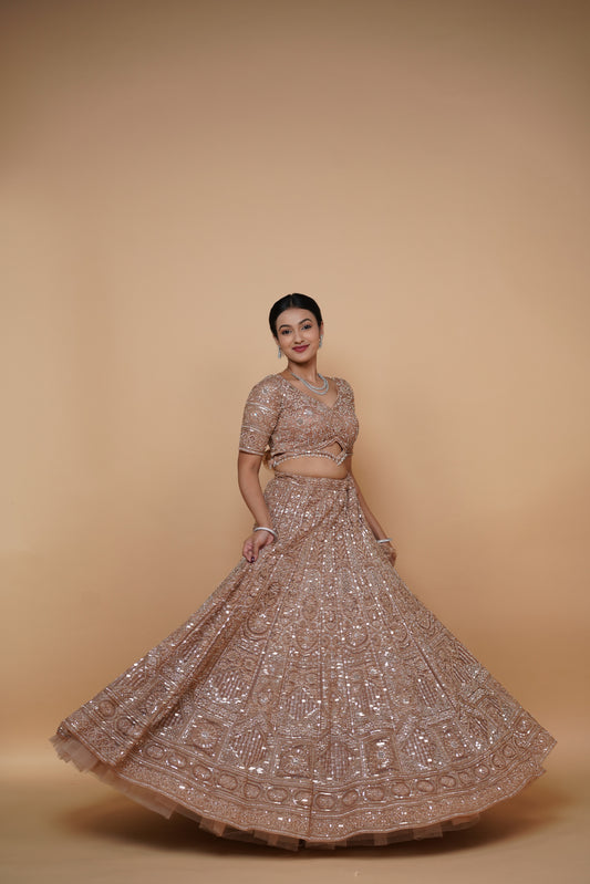 Bride wearing a heavy golden designer lehenga for wedding reception