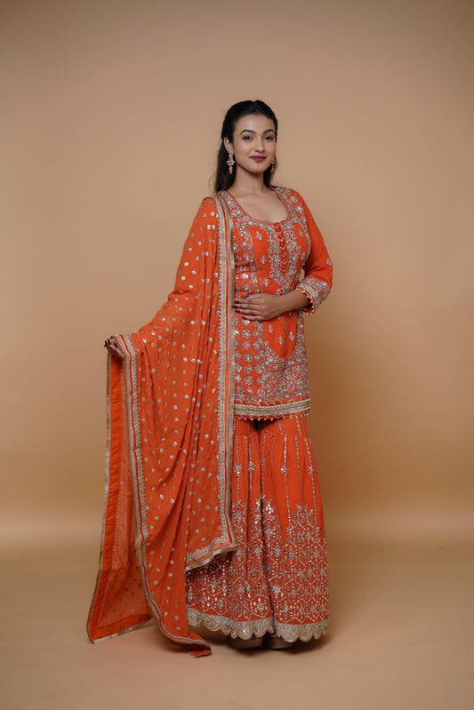 Bride wearing a heavy handwork designer sharara suit by Urban Dulhaniya