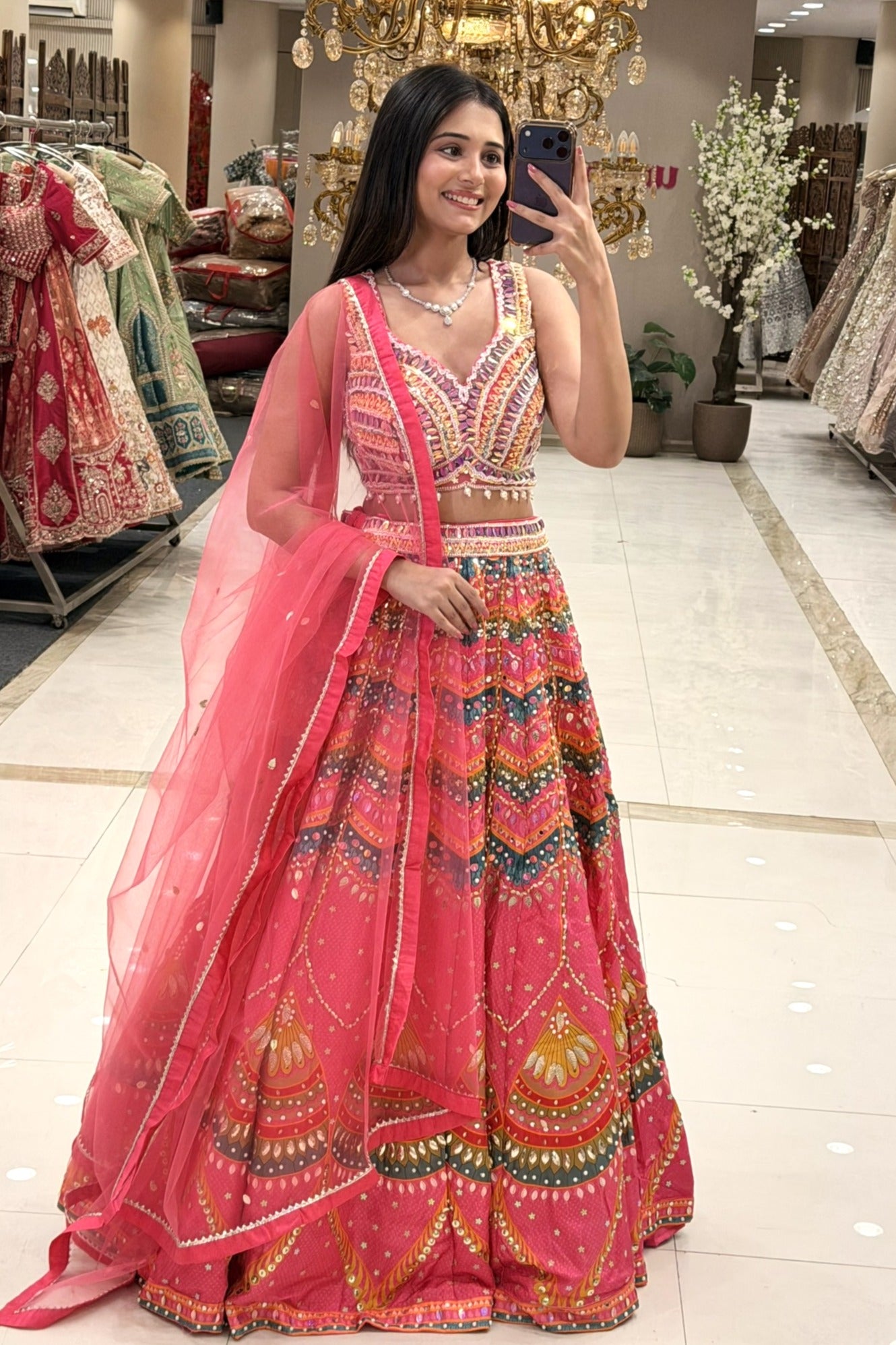 Full flared Patola print multicolour lehenga set with sequin embroidered choli and coral-pink net dupatta — Sangeet wear Urban Dulhaniya