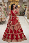 Red bridal lehenga with gold zardozi wrap blouse and pom pom dupatta – Urban Dulhaniya Pune.
Traditional red Indian bridal lehenga with gold cutdana – NRI bridal shopping at Urban Dulhaniya Pune