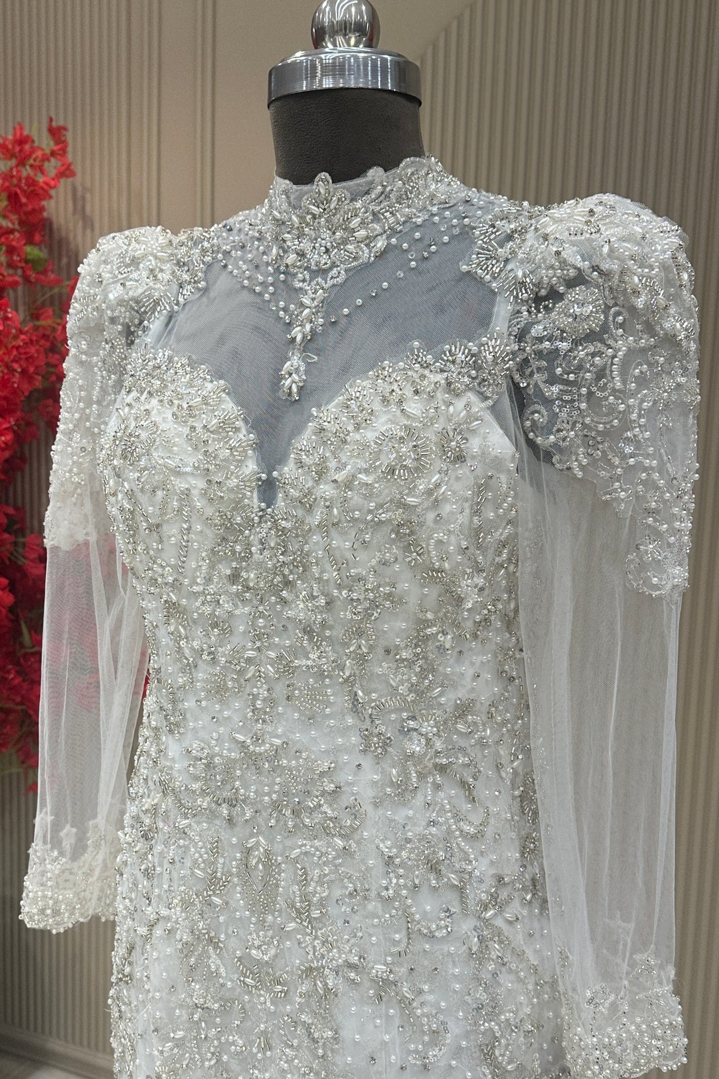Bust detail off white net long sleeve pearl gown designer bridal wear at Urban Dulhaniya Pune