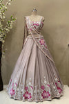 Detailed view of large floral motifs made with cut dana and poath moti on the border of a premium lehenga skirt.