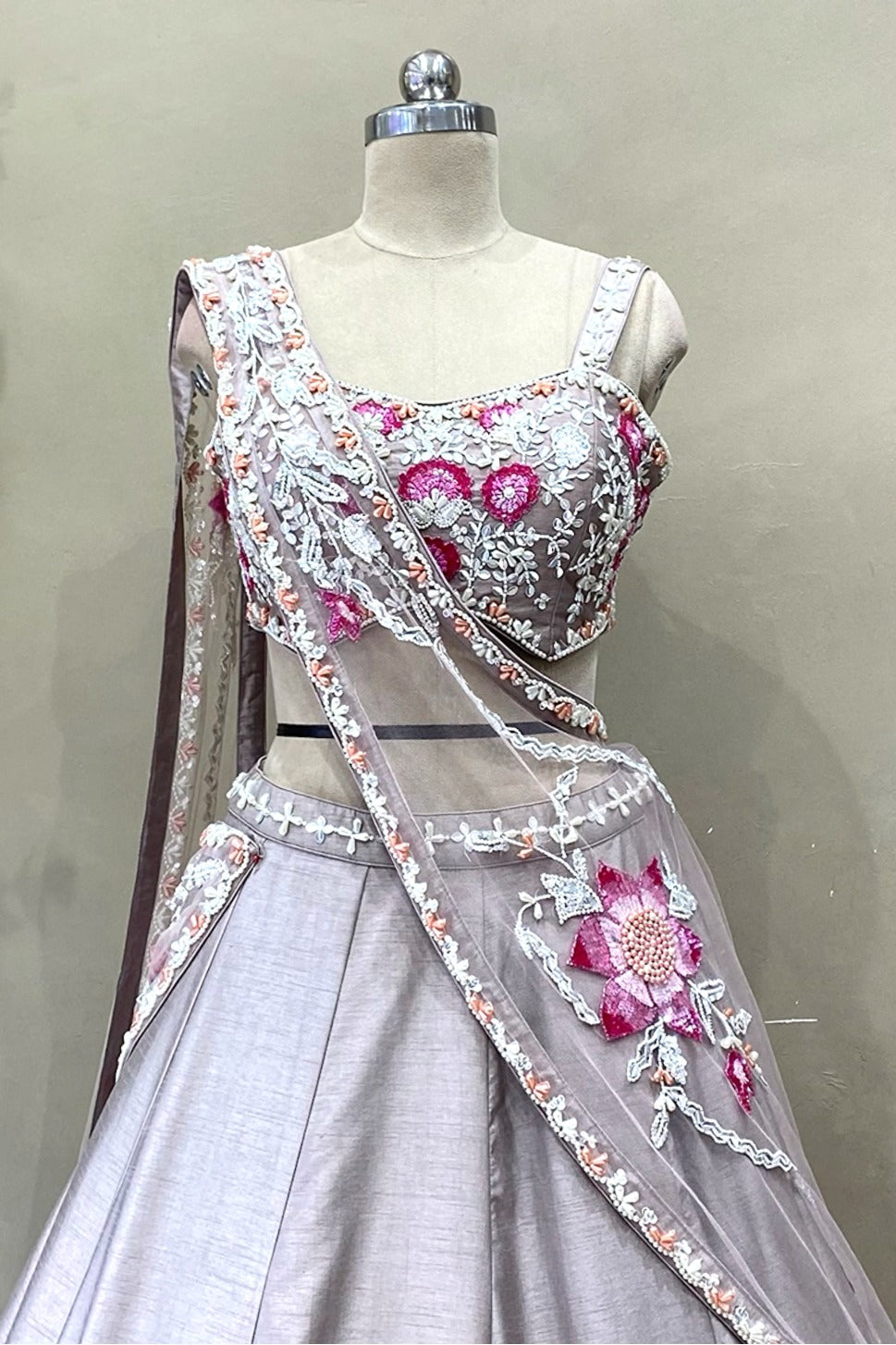 Close-up of choli featuring intricate poath moti, pearl work, and cut dana hand-embroidery on a mauve silk base.