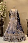 Full front view of a luxury midnight blue and ice blue ombre embroidered reception lehenga on a mannequin at Urban Dulhaniya.