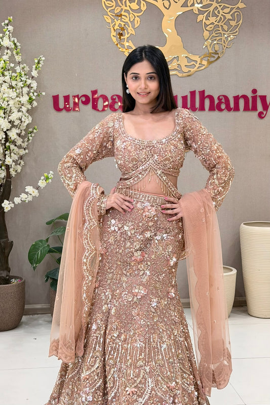 Peach mermaid bridal lehenga with full sleeve sheer blouse and scallop dupatta ,Urban Dulhaniya Pune.
Peach Indian bridal lehenga with rose gold sequin and handwork – NRI bridal shopping, Urban Dulhaniya Pune
