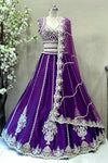 Luxury royal purple silk lehenga with vertical embroidery and scalloped border for bridal sangeet or reception.