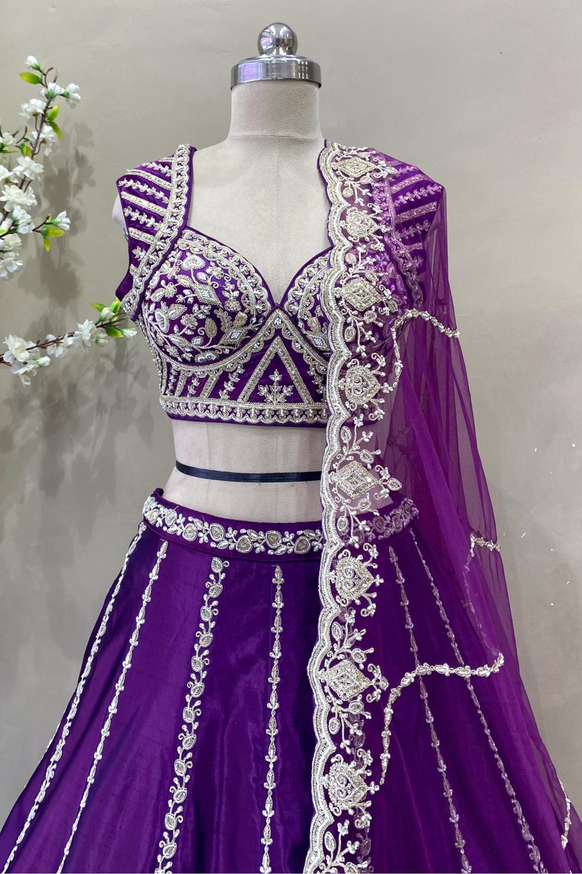 Close-up of heavy silver beads and sequin embroidery on royal purple designer choli blouse.