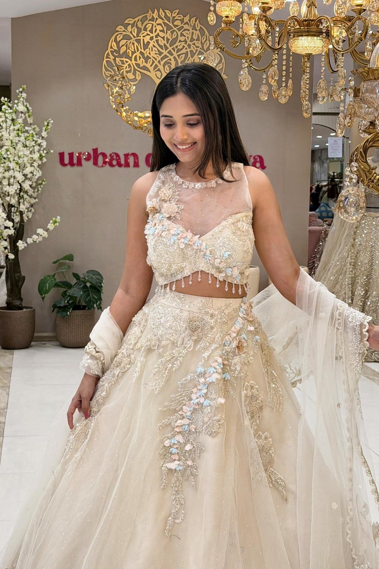 Ivory bridal lehenga blouse with sheer neckline, crystal tassels and 3D floral skirt – Urban Dulhaniya