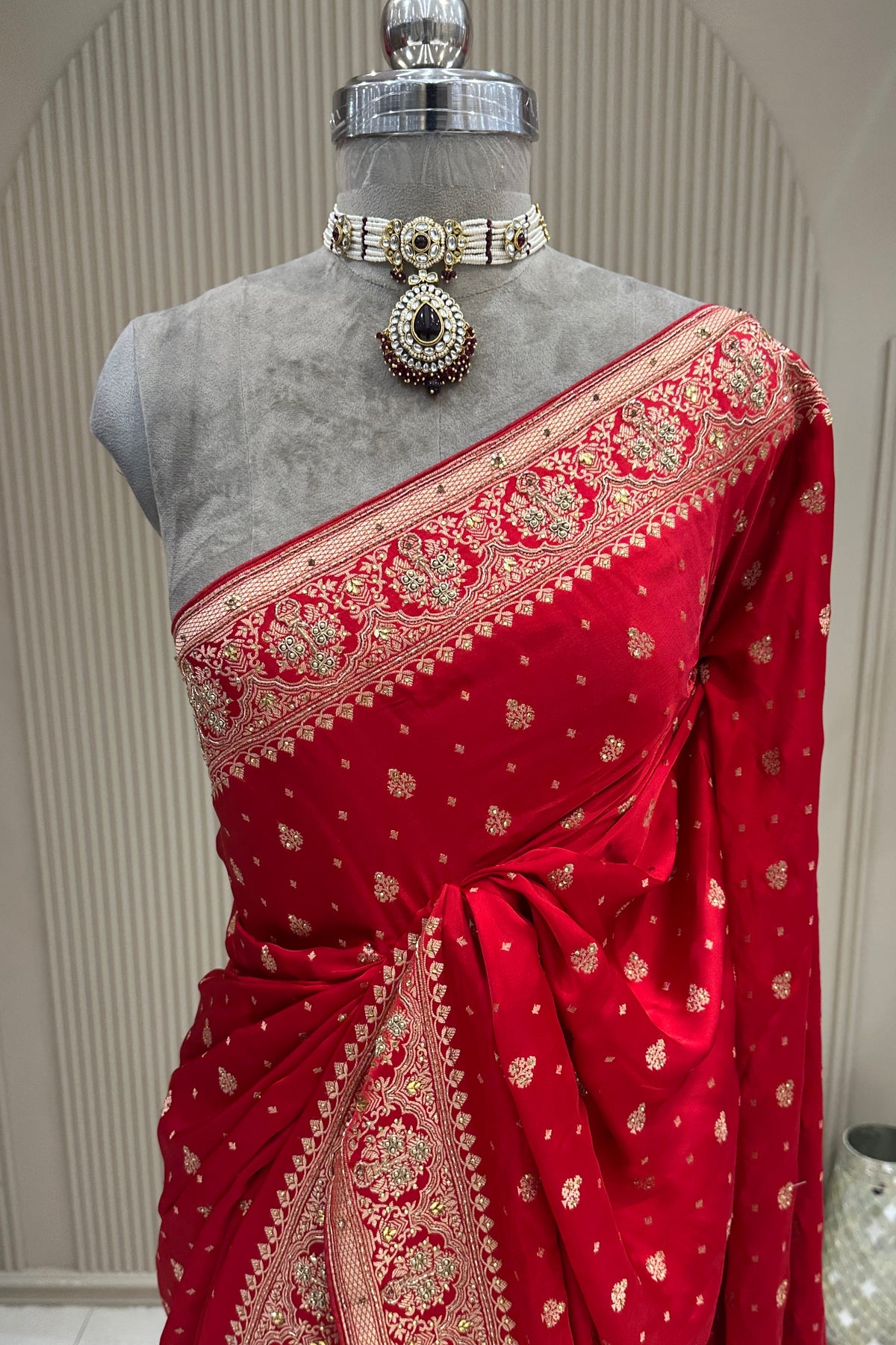 Upper front drape view red satin silk saree with moti zardoshi cutdana, premium ethnic wear from Urban Dulhaniya