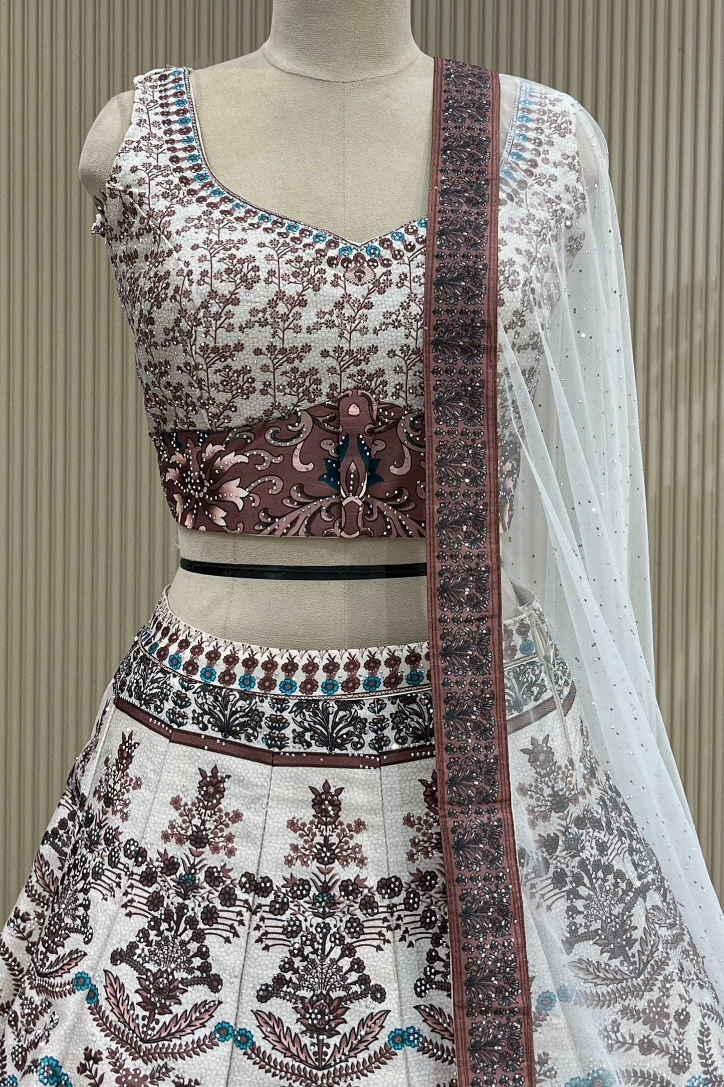 Close-up of floral print blouse, contrast waist panel, and lehenga waistband