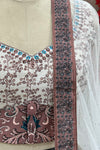 Detail shot of blouse neckline, contrast waist buckle print, and dupatta border