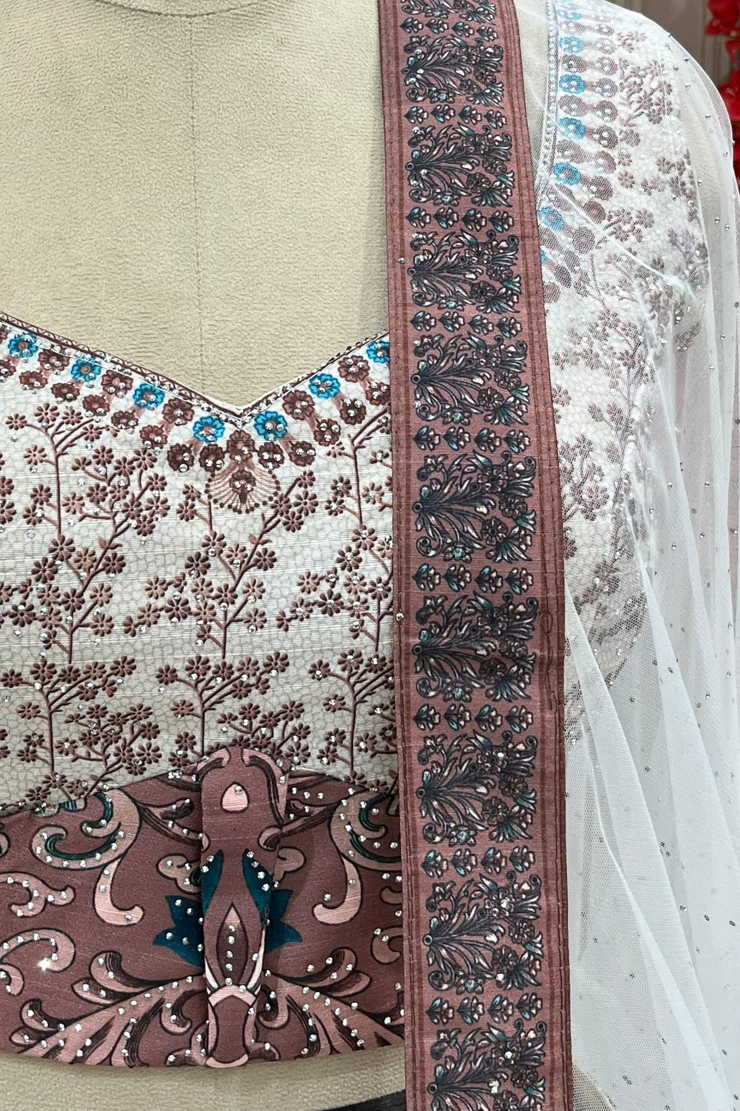 Detail shot of blouse neckline, contrast waist buckle print, and dupatta border