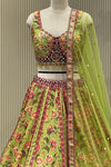 Pistachio lehenga set showing floral print and scalloped maroon border panel