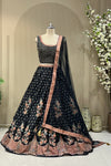 Black lehenga set showing scattered floral print and coral paisley border
