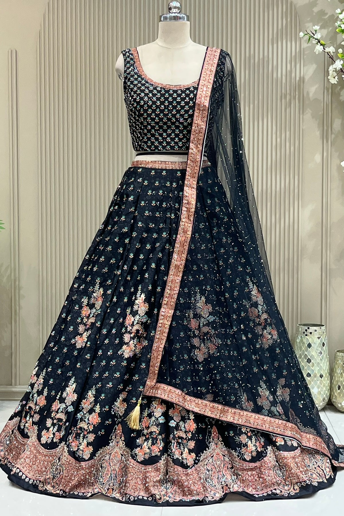 Front view of black printed blouse and lehenga with sequin net dupatta drape