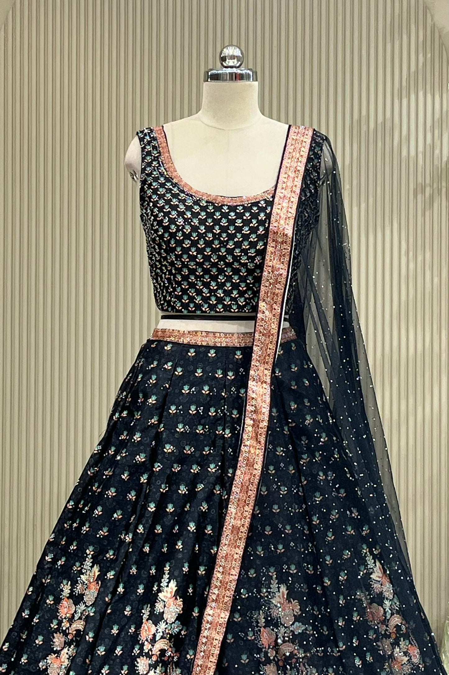 Close-up of black printed blouse and coral border trim detail
