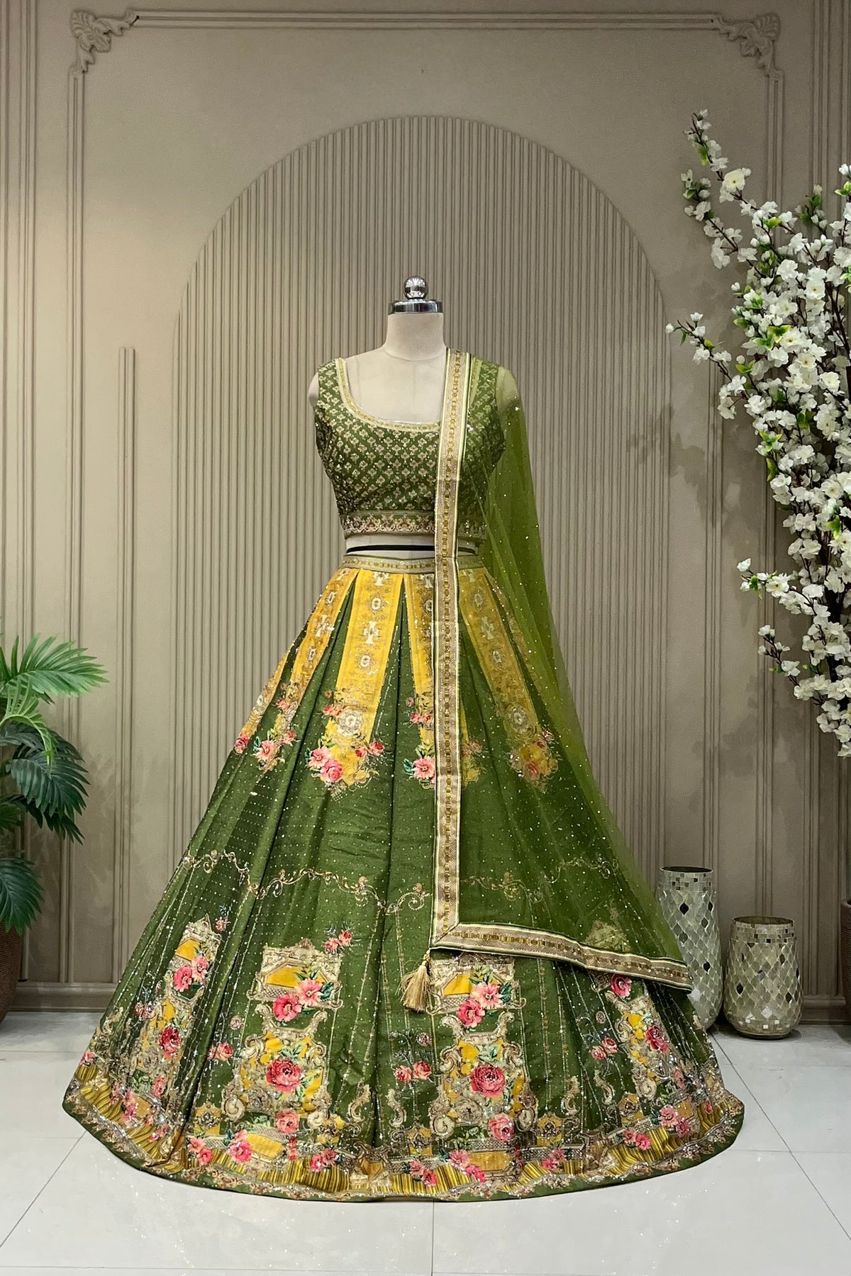 Olive green and mustard panelled printed lehenga, full front view on mannequin with sequin net dupatta