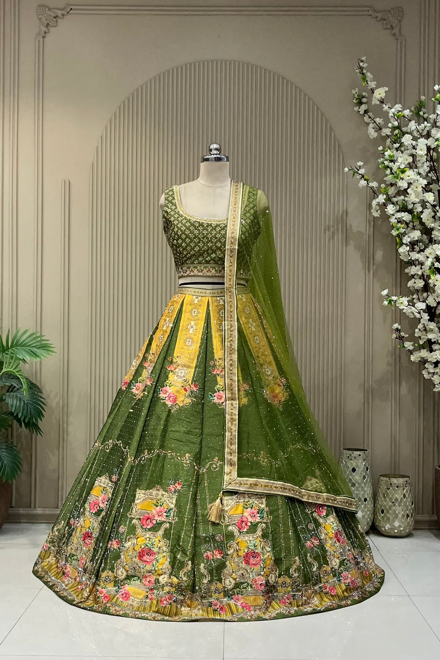 Olive green and mustard panelled printed lehenga, full front view on mannequin with sequin net dupatta