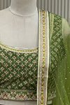 Close-up front view of printed blouse and lehenga waistband with lace trim