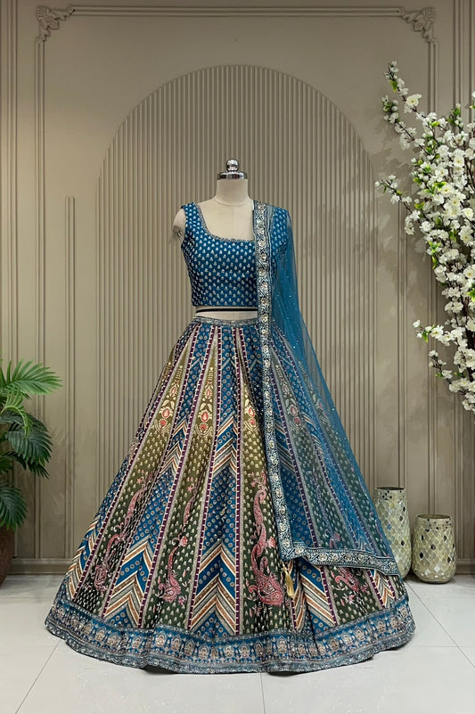 Teal blue printed lehenga with chevron panel skirt, full front view on mannequin with net dupatta