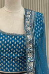 Detail shot of blouse neckline and black-and-white paisley dupatta border with stone highlights