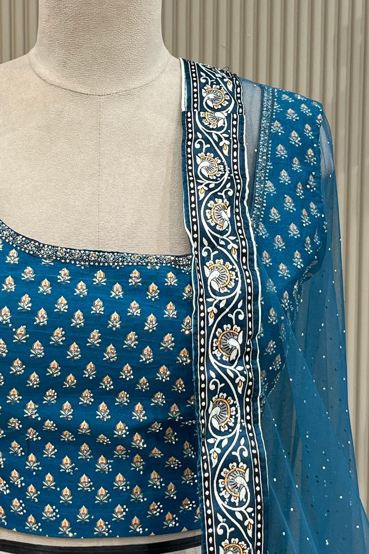 Detail shot of blouse neckline and black-and-white paisley dupatta border with stone highlights