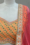  Close-up of mustard floral print blouse and rust net dupatta border with stone detail