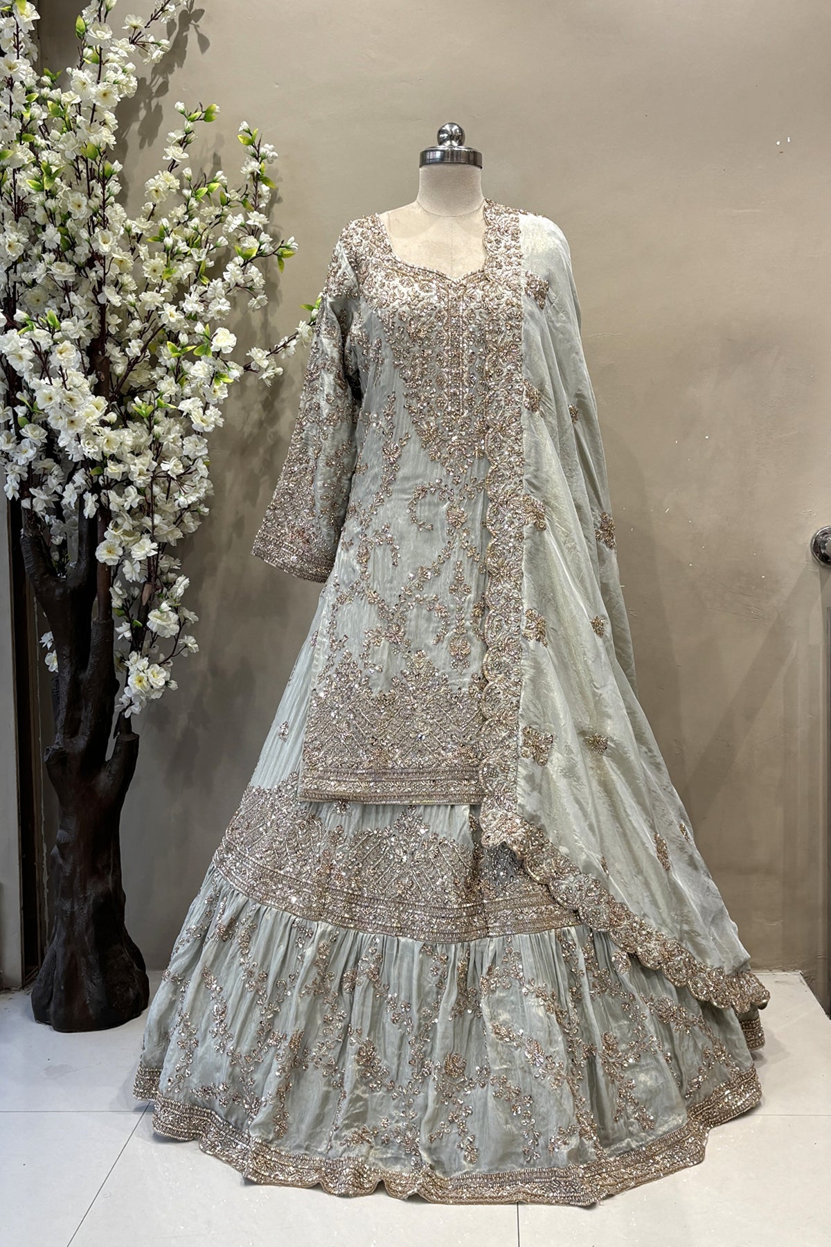 Designer sage green long kurta lehenga set with flared skirt and scalloped dupatta for brides.