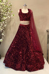 Full-body shot showcasing the voluminous flared skirt and dense sequin fabrication of a premium ruby red sangeet lehenga.