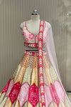 Front view of mirror-work blouse and pastel skirt with sheer dupatta drape