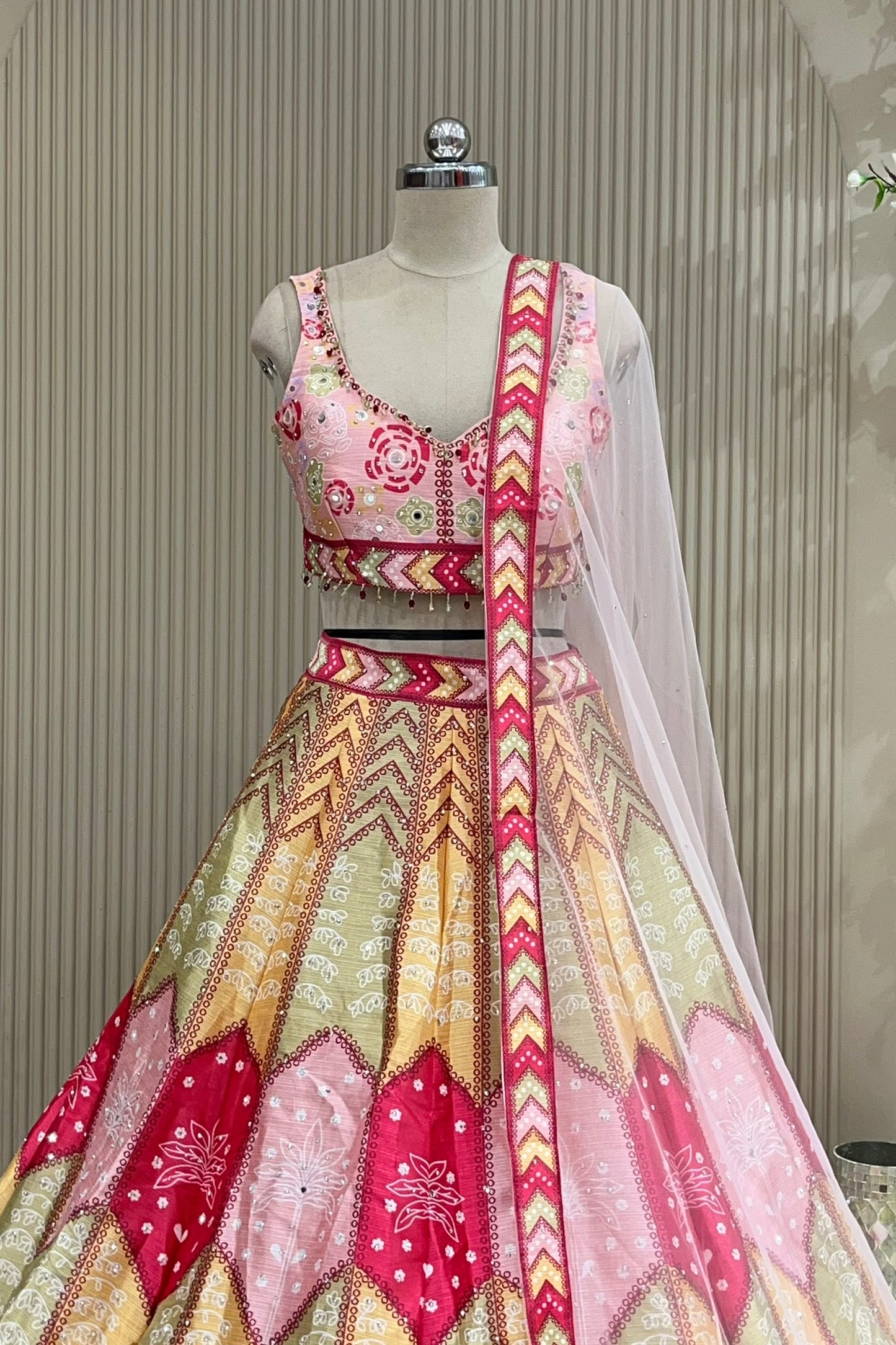 Front view of mirror-work blouse and pastel skirt with sheer dupatta drape