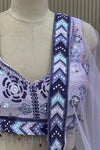Close-up of mirror-work blouse neckline, beaded tassel trim, and chevron border detail