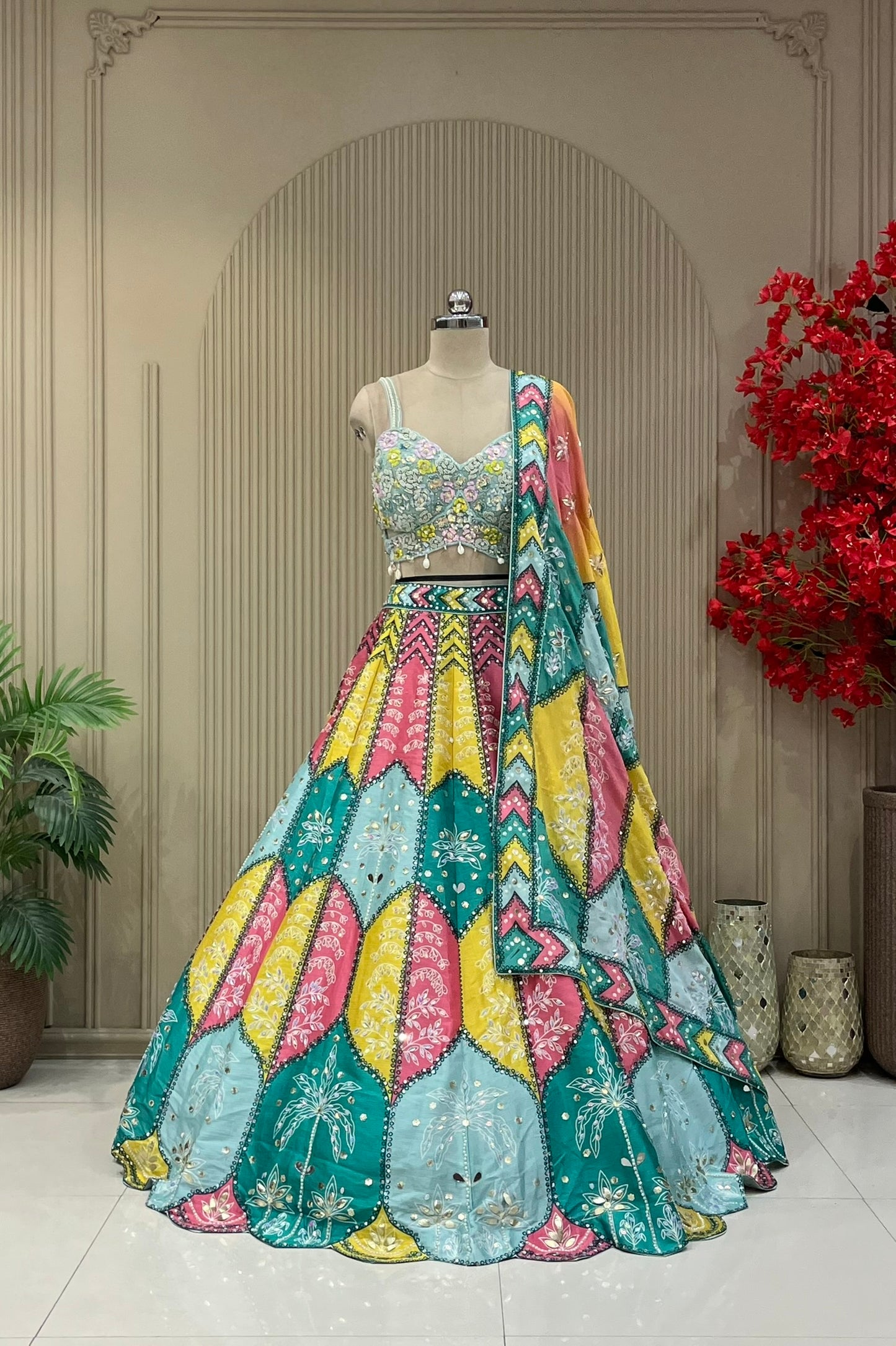 Multicolor lehenga set showing teal, mustard, and pink scallop skirt panels