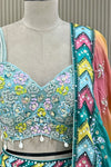 Close-up of blouse sequin, bead, and pearl floral embroidery with shell tassels and mirror border detail