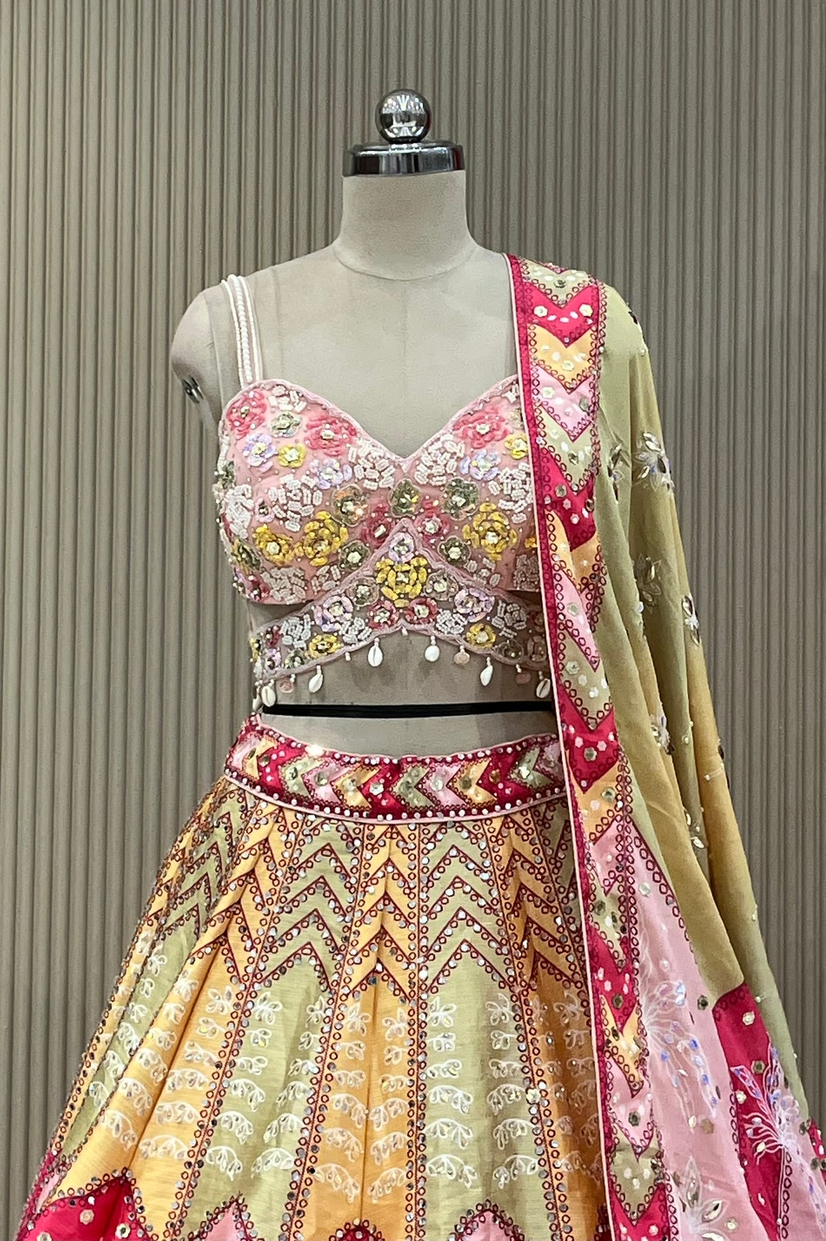 Front view of hand-embroidered sweetheart blouse with shell tassel trim and mirror border dupatta