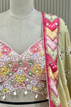  Close-up of blouse sequin, bead, and pearl floral embroidery with shell tassels and mirrored chevron border detail